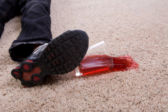 Red juice being spilled on a carpet