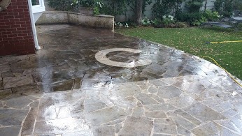 Stone patio being cleaned by powerwashing