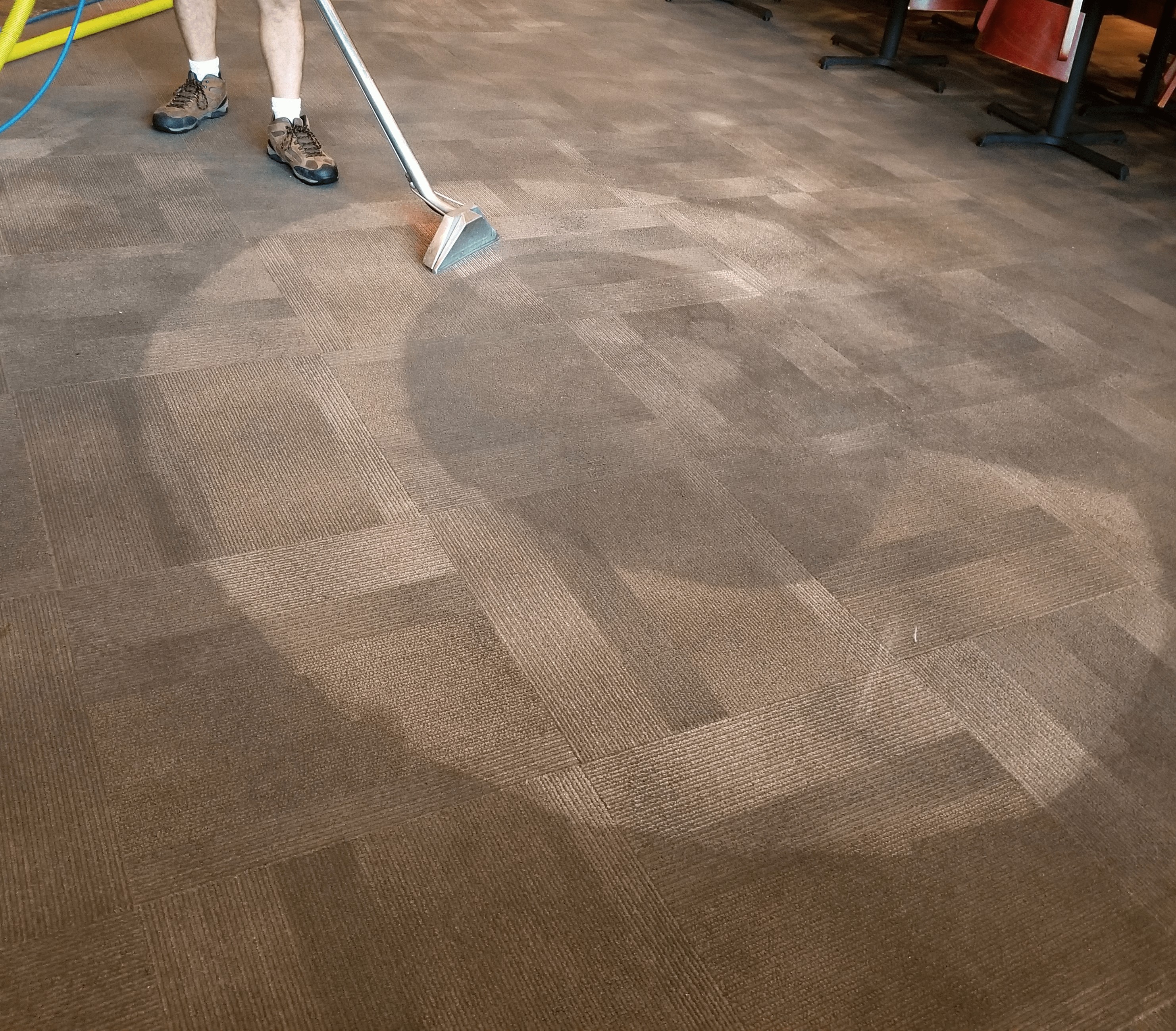 A man cleaning the carpets in a Plano Texas restaurant