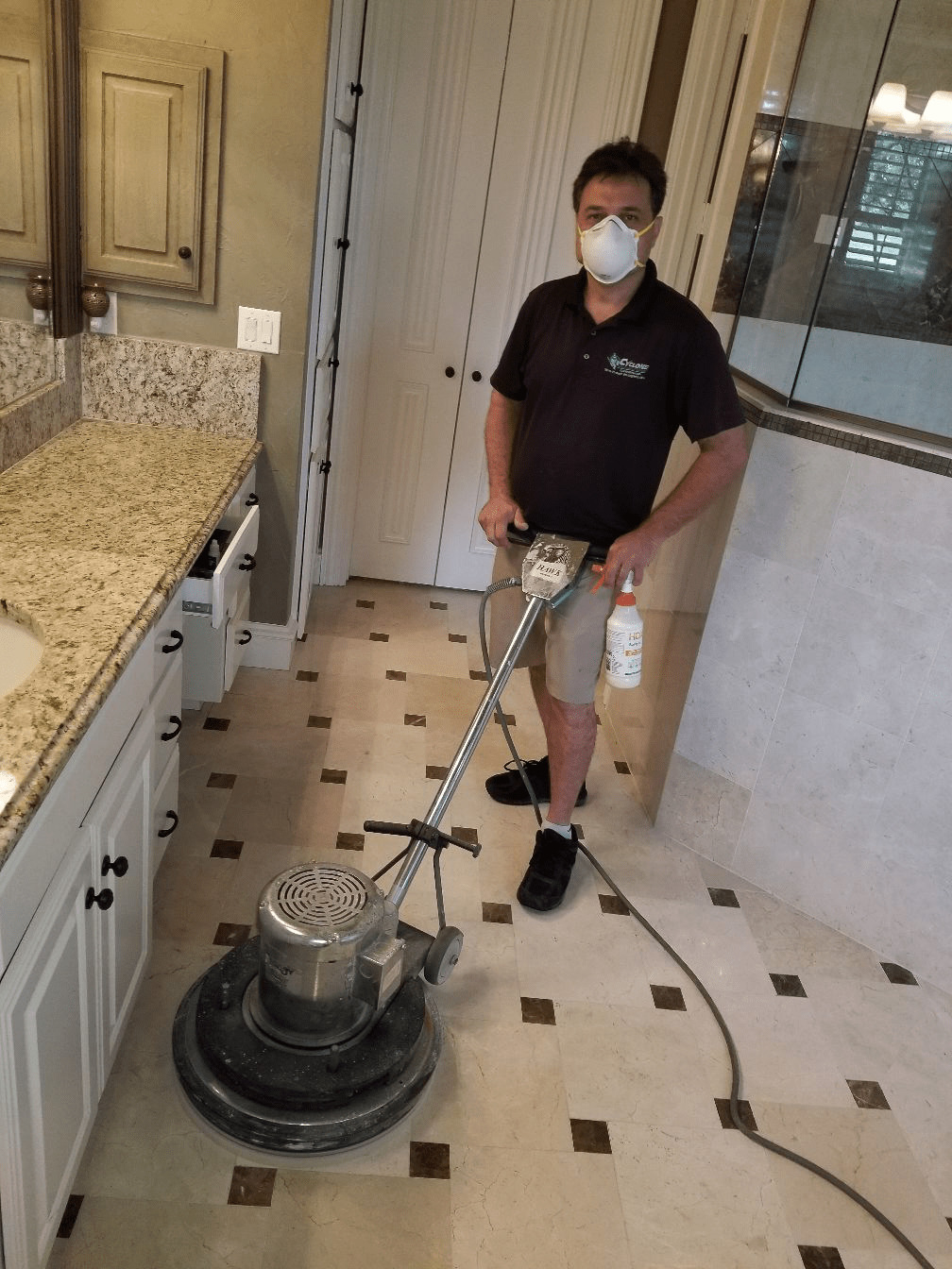 Wearing a mask while restoring a marble bathroom floor in McKinney Texas on 7/14/20