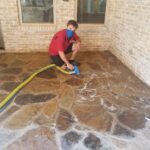 Wearing a mask while cleaning and sealing an outdoor marble floor