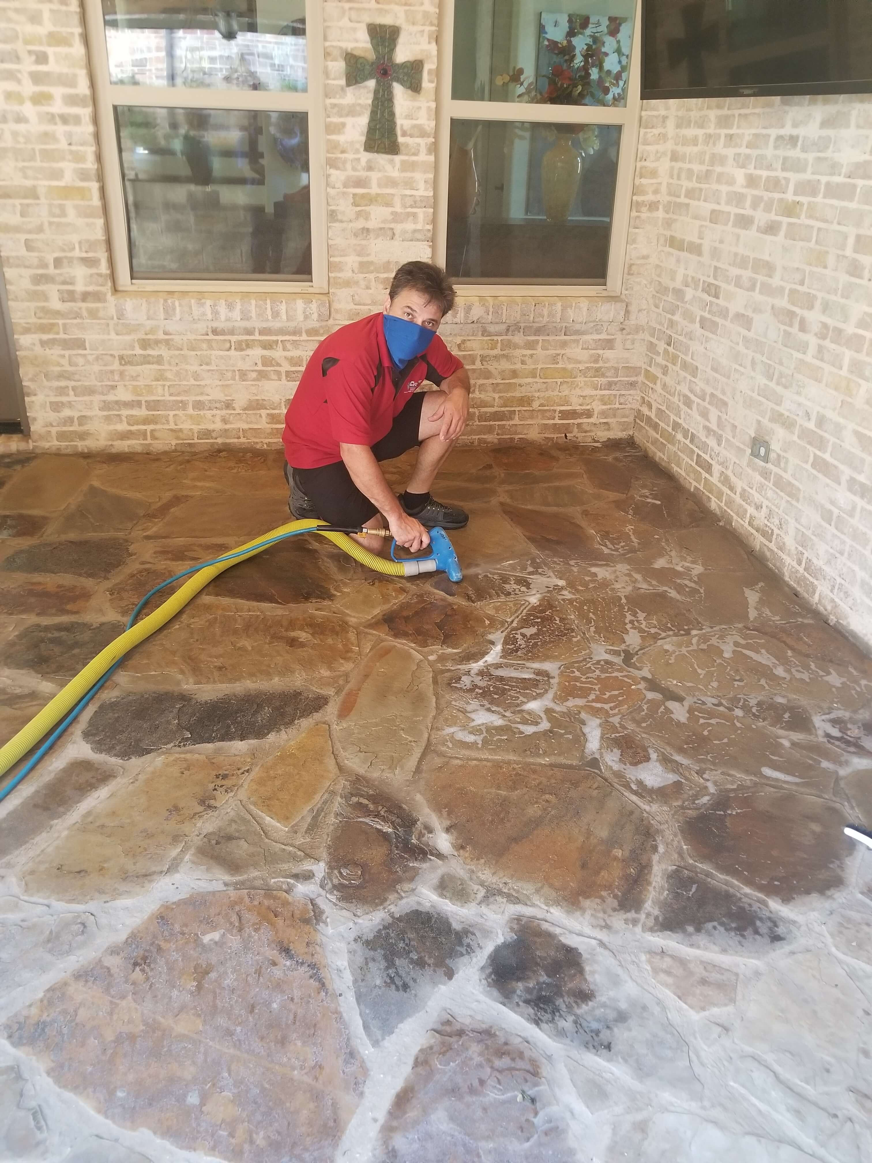 Wearing a mask while cleaning and sealing an outdoor marble floor